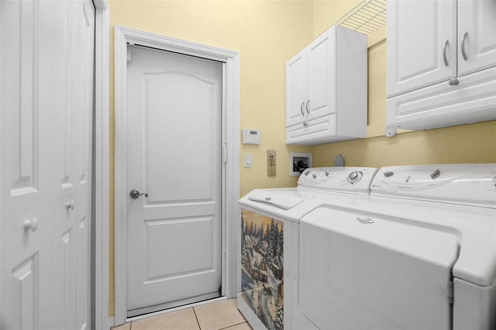 Large pantry closet and extra cabinets in laundry room