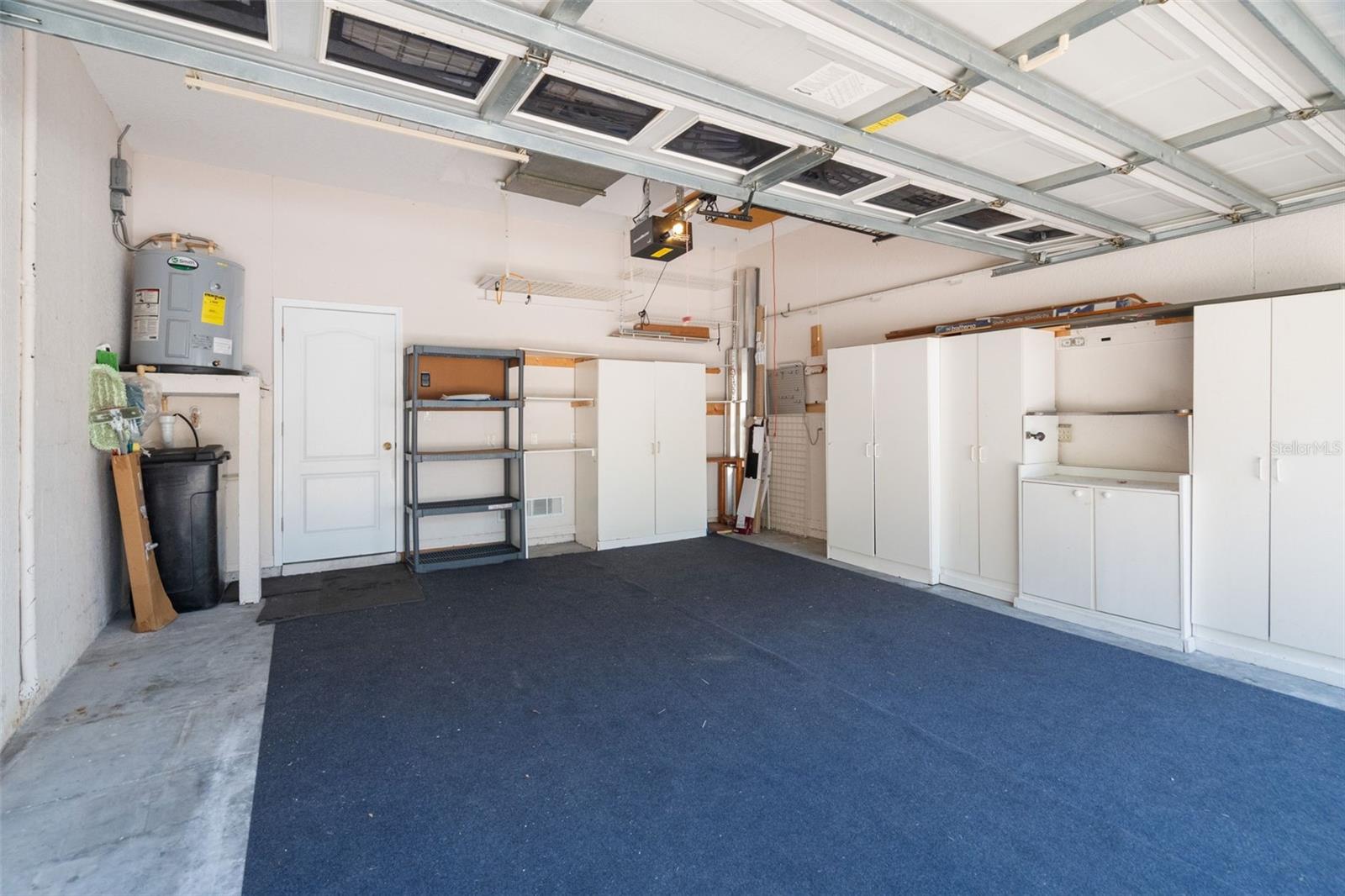 Two car garage with extra shelving and storage