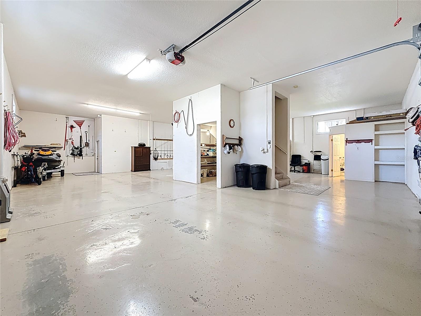 Spectacular Garage that includes workshop area, under stairs storage, Full Bath, Soaring ceiling allow for RV or Boat storage, room for 5+ vehicles