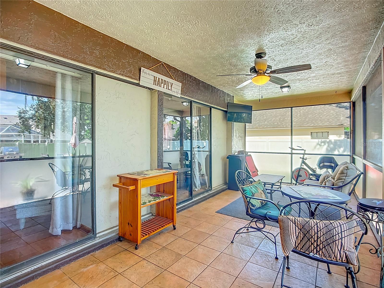 Ceramic tile, ceiliing fan , and views of yur private oasis backyard.