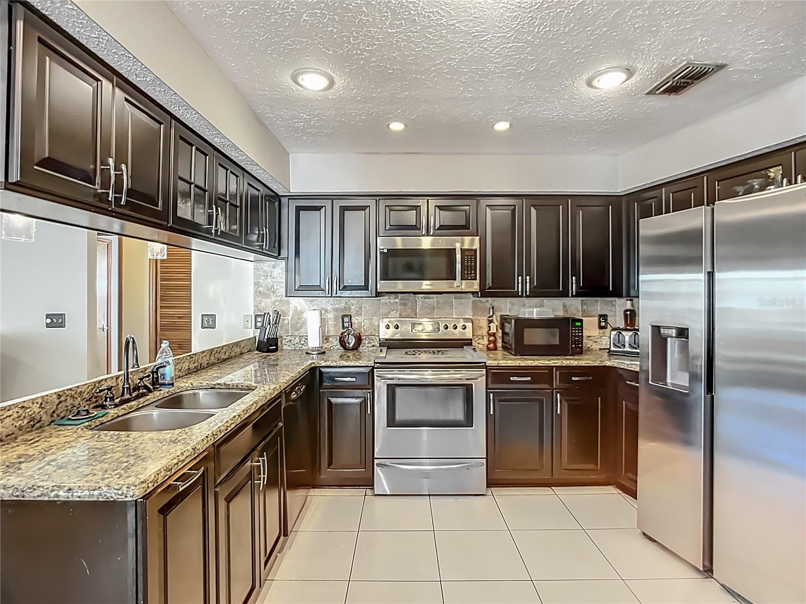 Plenty of cabients and granite counter tops.