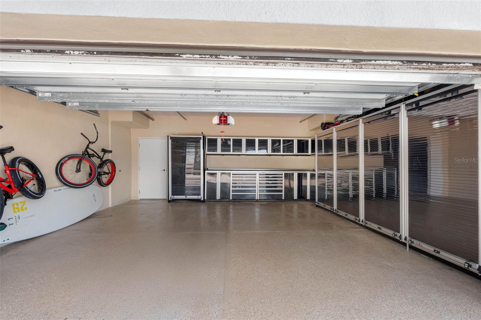 air conditioned two car garage with workshop cabinetry access to inside elevator to unit