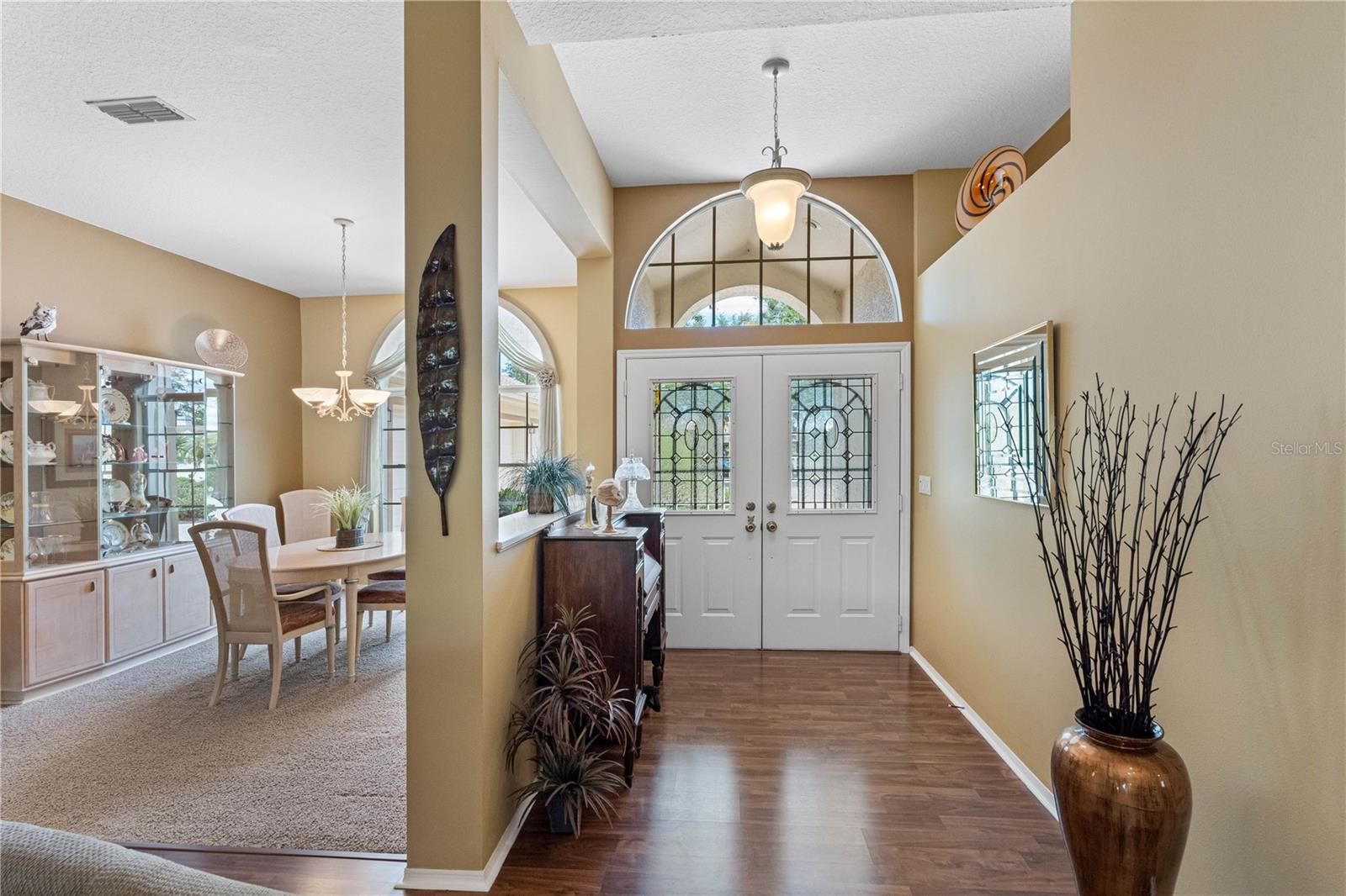 Foyer is welcoming with grand double door entry