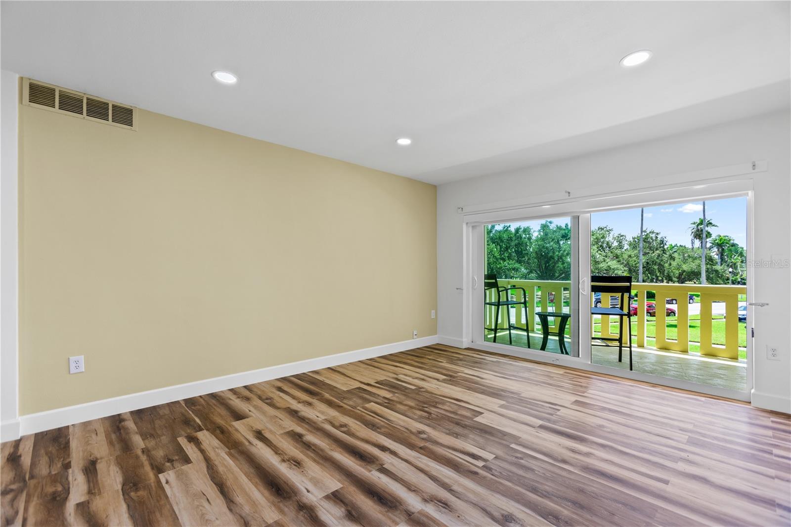 Primary bedroom with sliding doors to large balcony