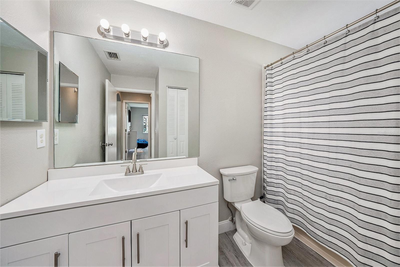 Secondary hall bath with new vanity and linen closet