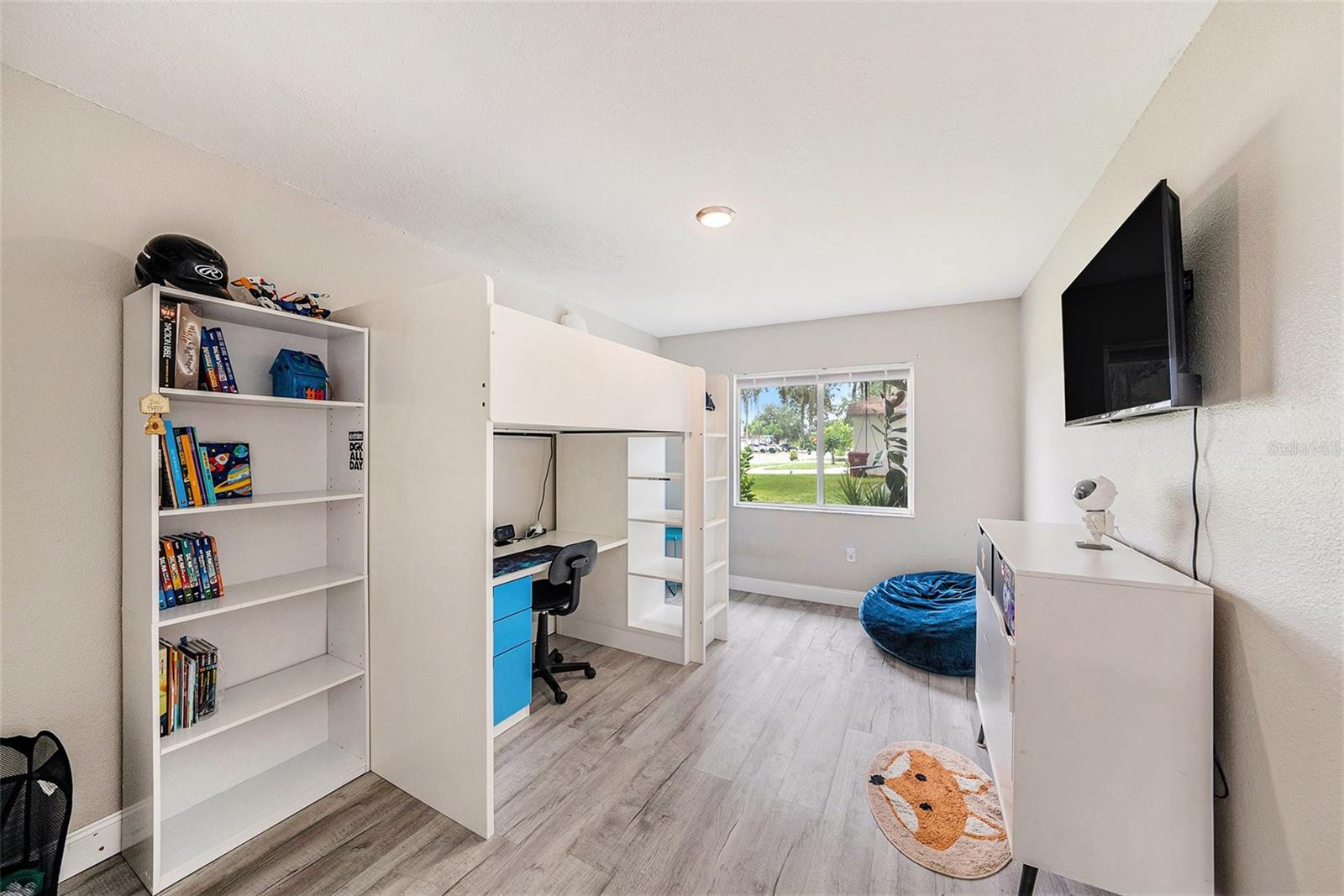 Secondary bedroom with large window overlooking yard