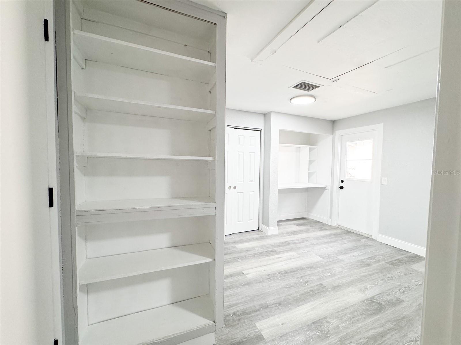 Primary Closet #1, Work area and Bookshelf.