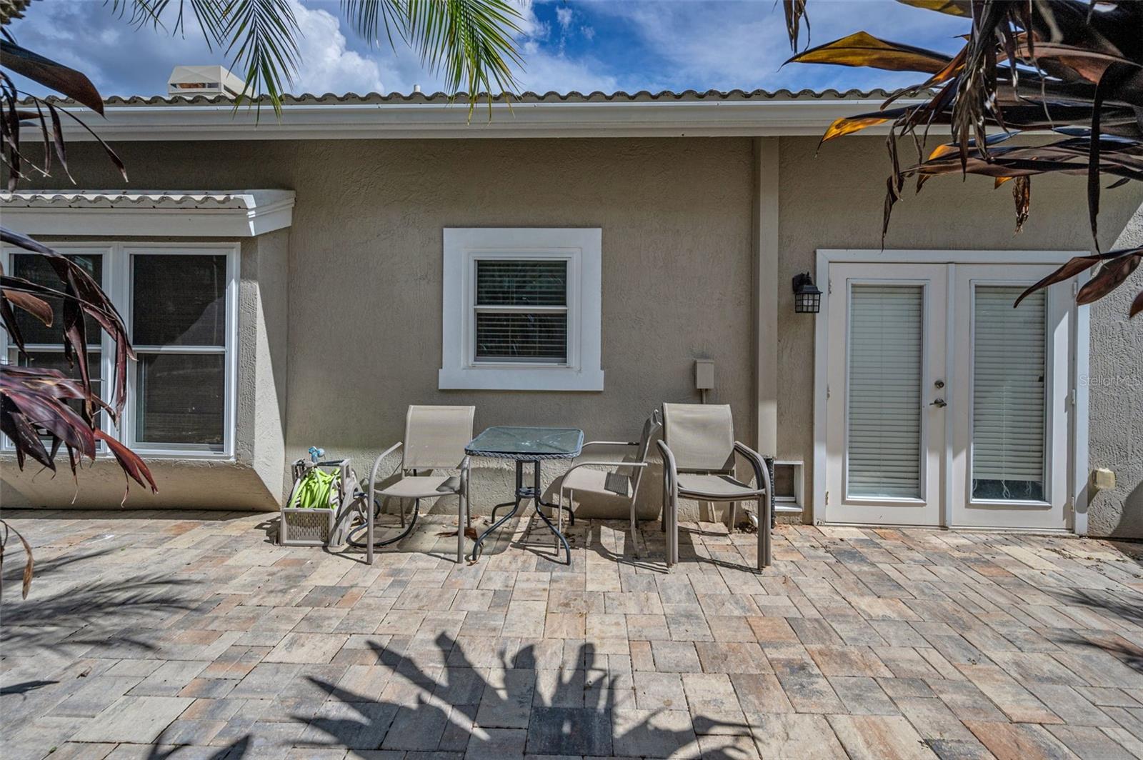 Side patio can be accessed from pool area or kitchen