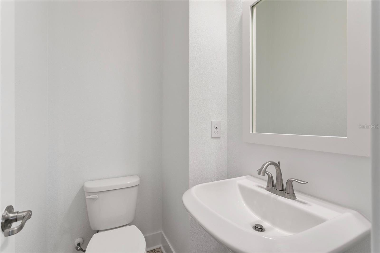 1/2 bath on main living space by dining room and staircase