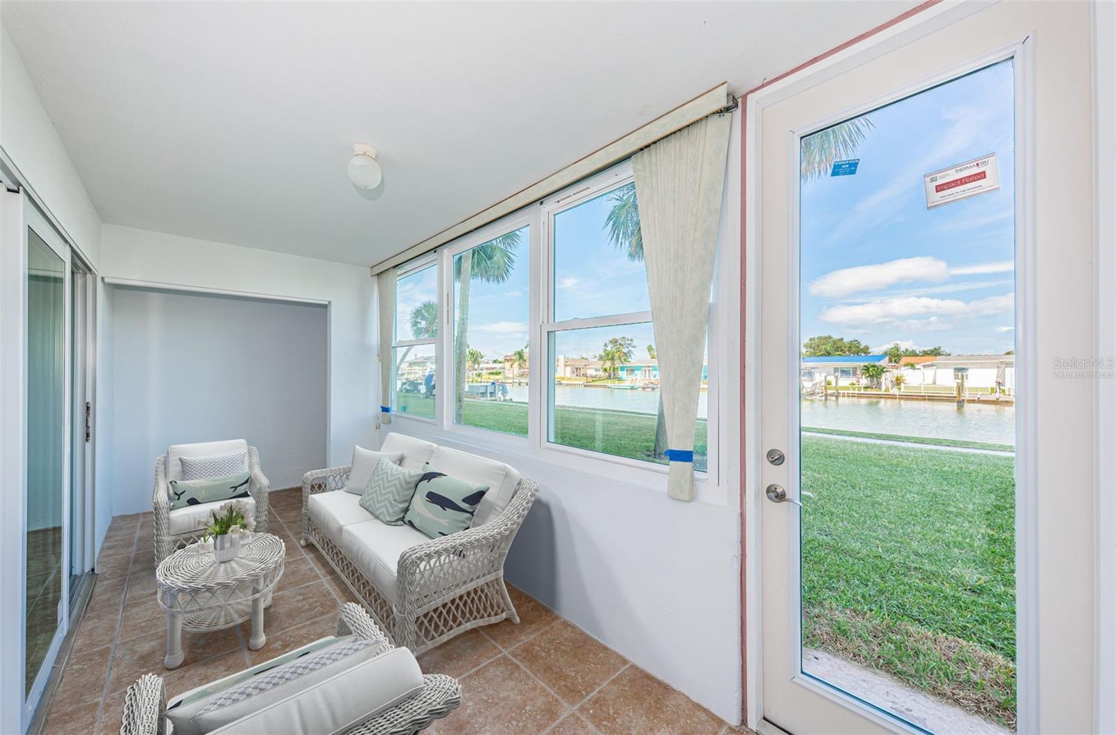 Virtually staged - Florida Room with new hurricane door and sliders
