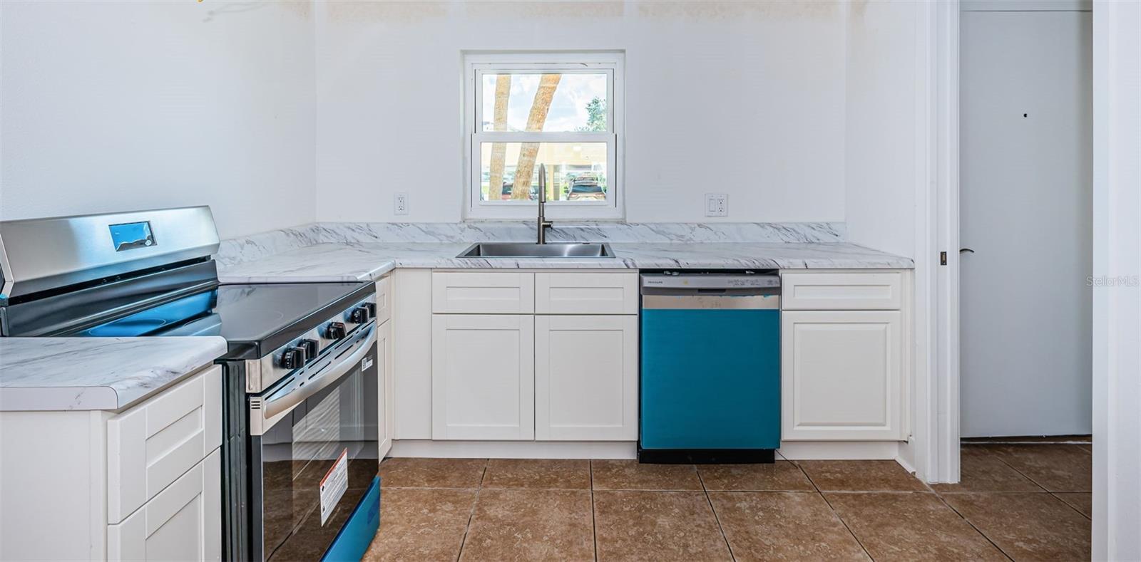Kitchen stainless steel appliances - wood bottom cabinets...waiting for the new owner to put on the finishing touches