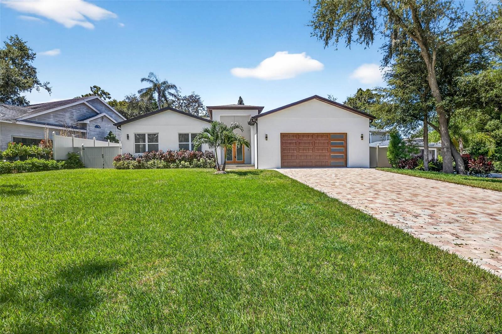 Front view of home with long paver driveway