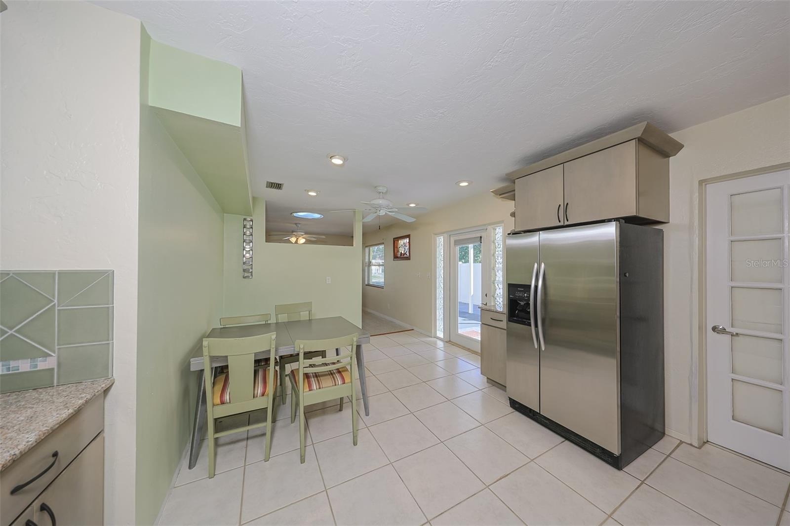 Dining and kitchen with the door to the laundry room on the right