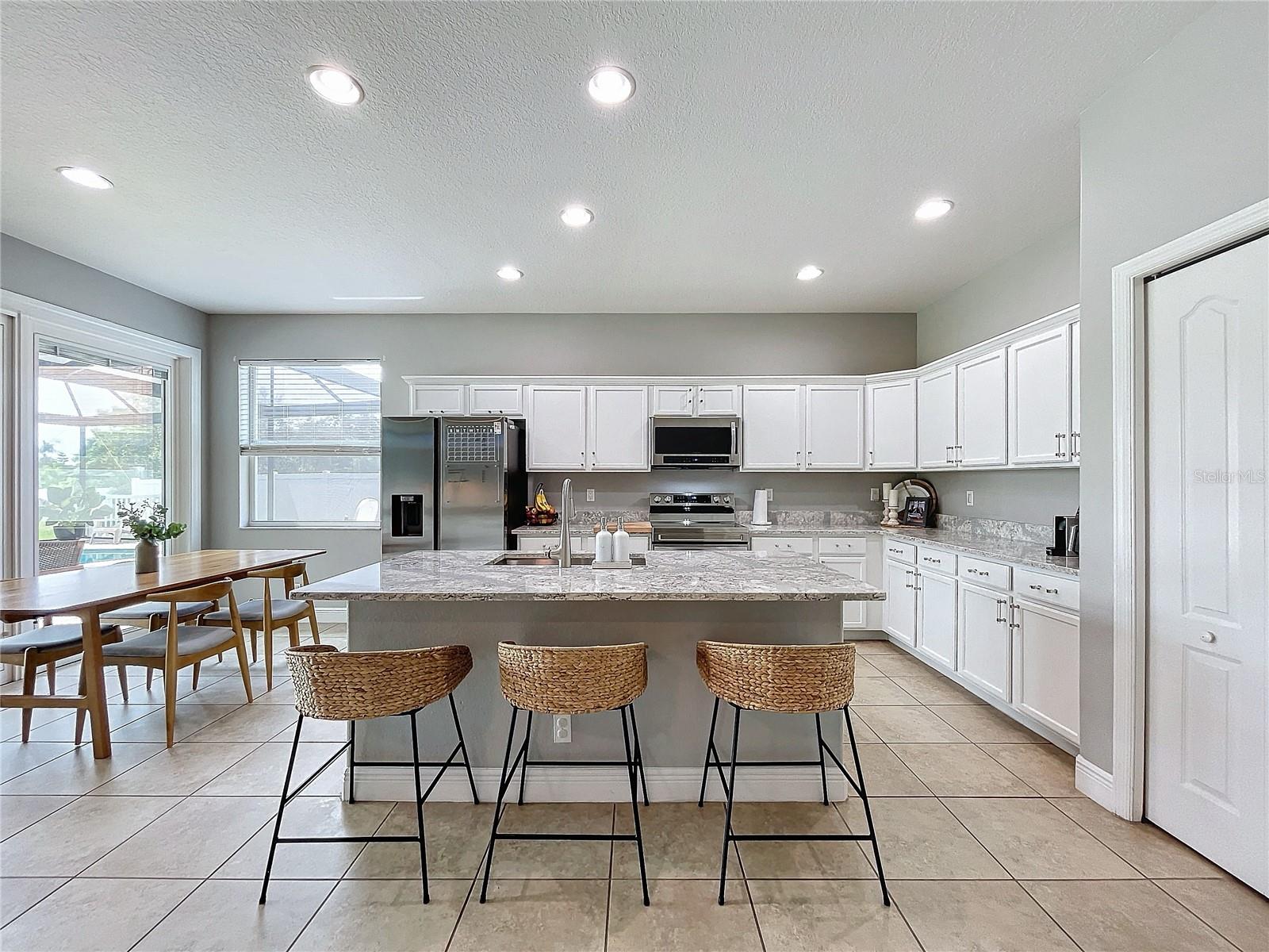 Kitchen with bar seating - Shown as it looked when the owner called it home.