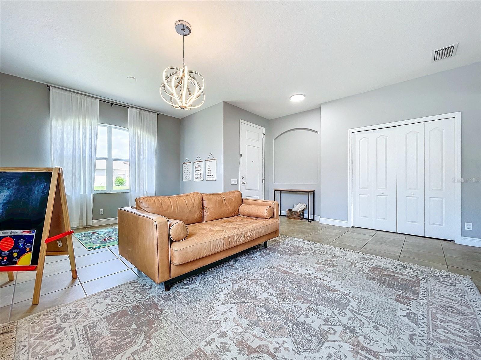Front Entrance / Family Room - Shown as it looked when the owner called it home.
