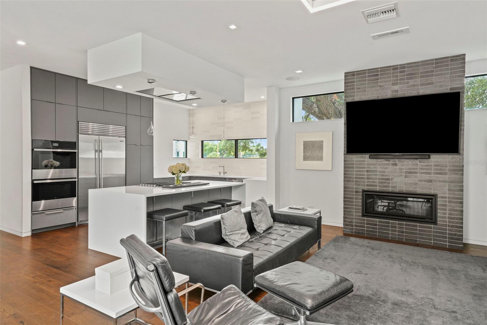 Family room features gas fireplace and artfully placed windows