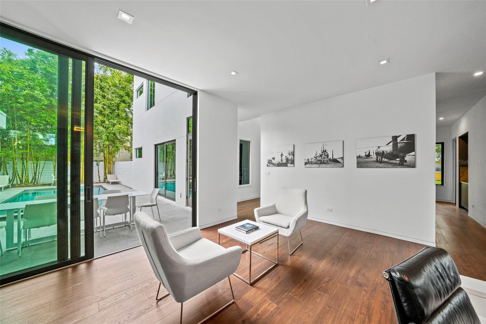 Wall of sliders leads to outdoor oasis