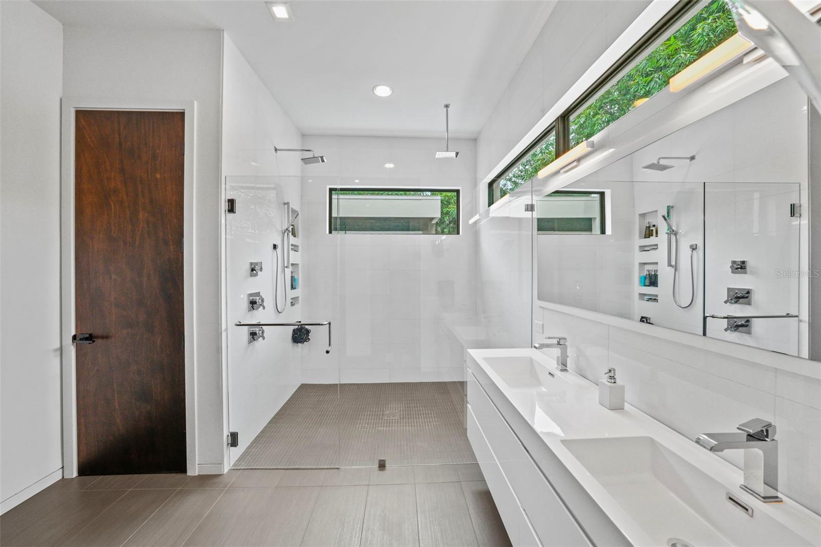 a dual sink, floating vanity and large shower