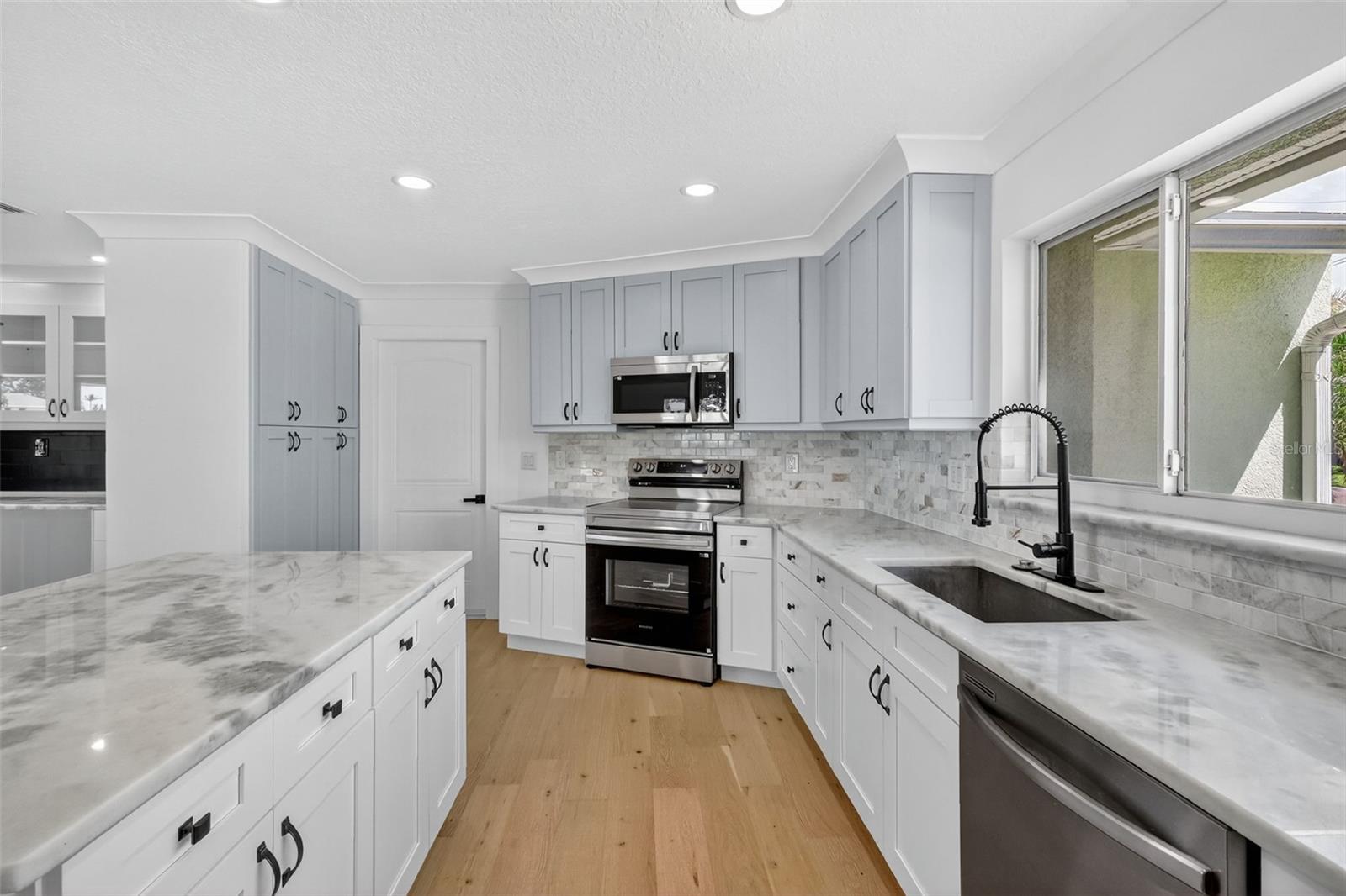 The kitchen has a large built in pantry and a doorway to the garage