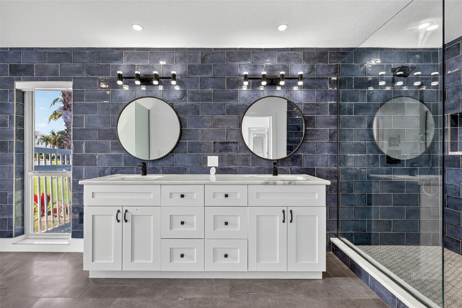 The En-Suite has a dual sink vanity and tiled walls and shower for ease