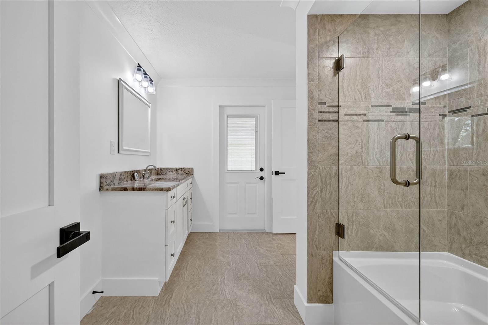 The Second Bath leads out to the pool area for convenience