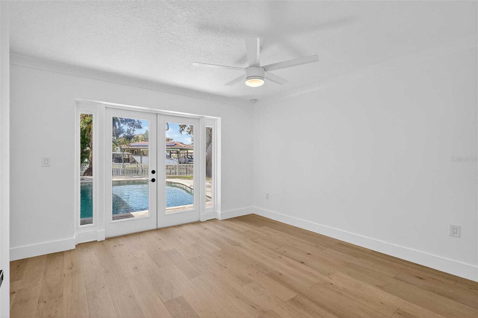 Bedroom 2 has French Doors leading out to the pool area