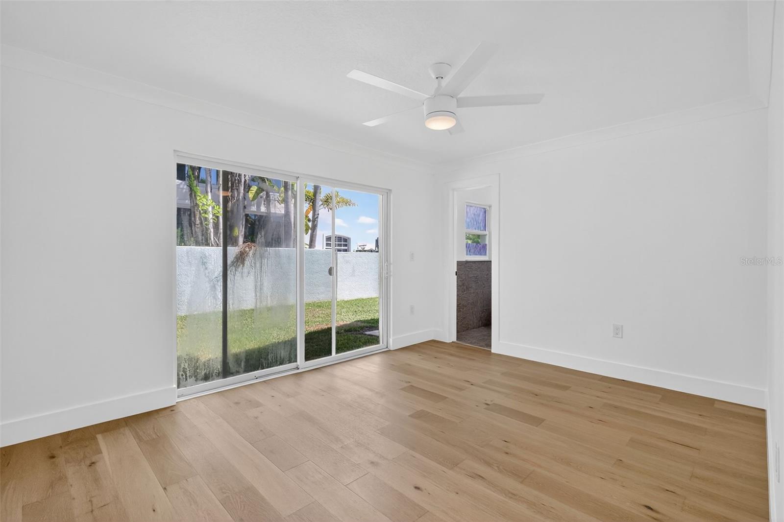 Bedroom 3, has Sliding doors that lead out into the yard area and an En-Suite bath