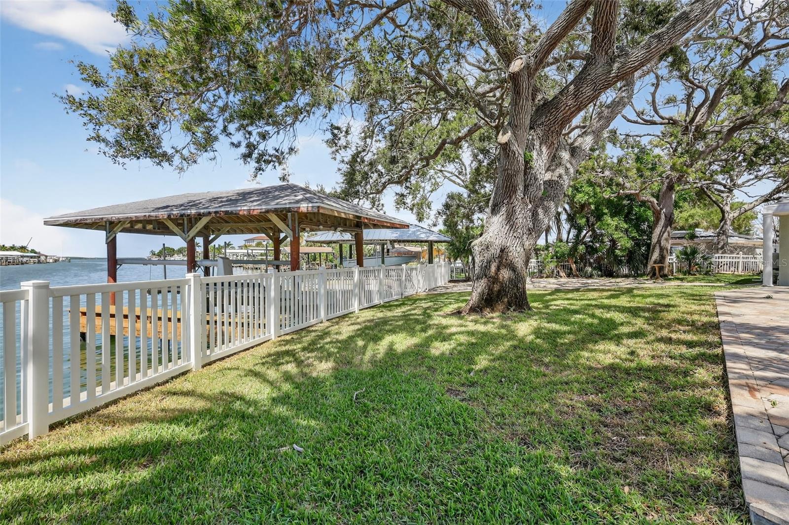 The fenced back yard lead to the Boat House and dock