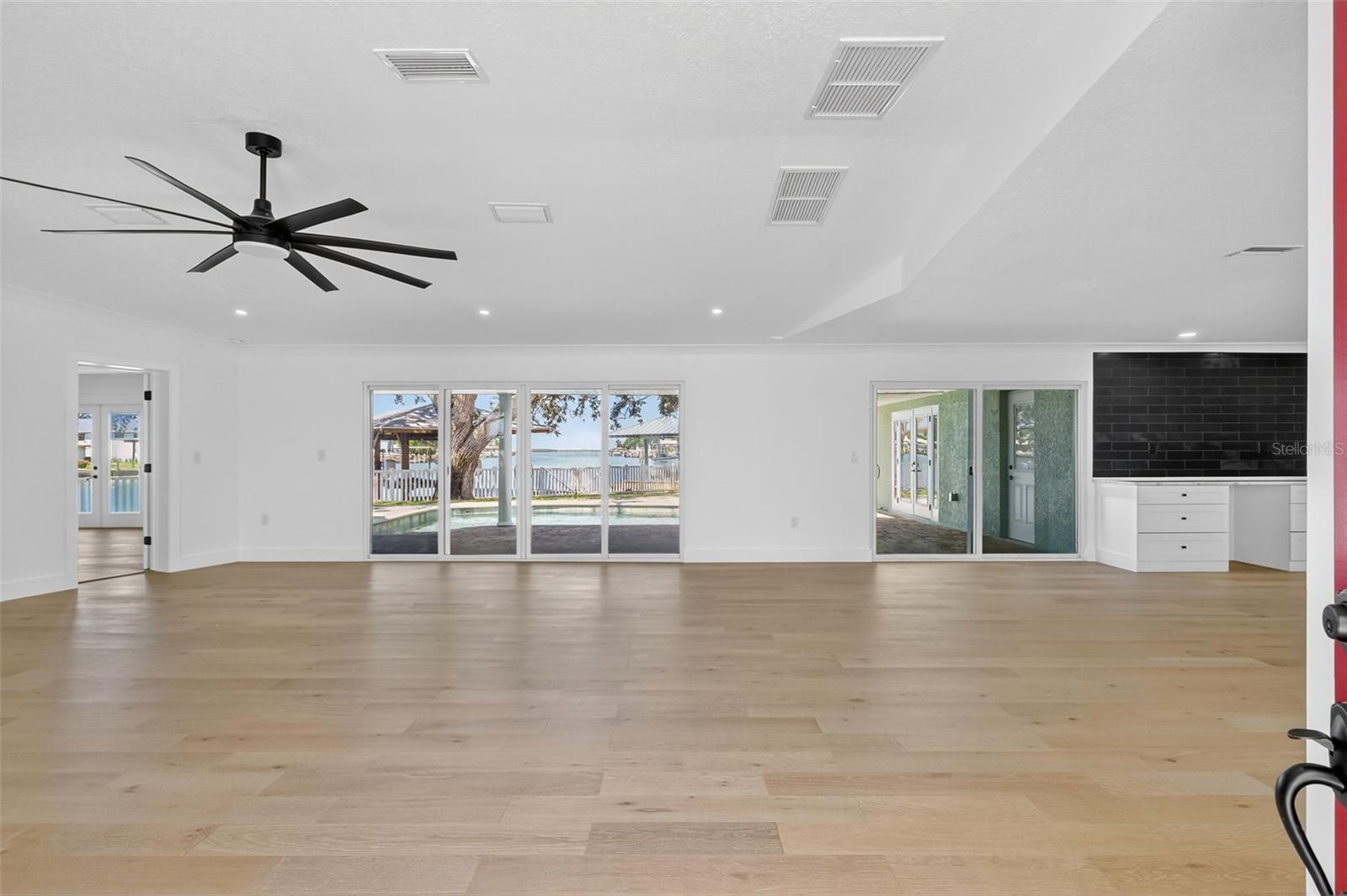 The living area is light and bright and you have 2 sets of sliders which lead out to the pool area