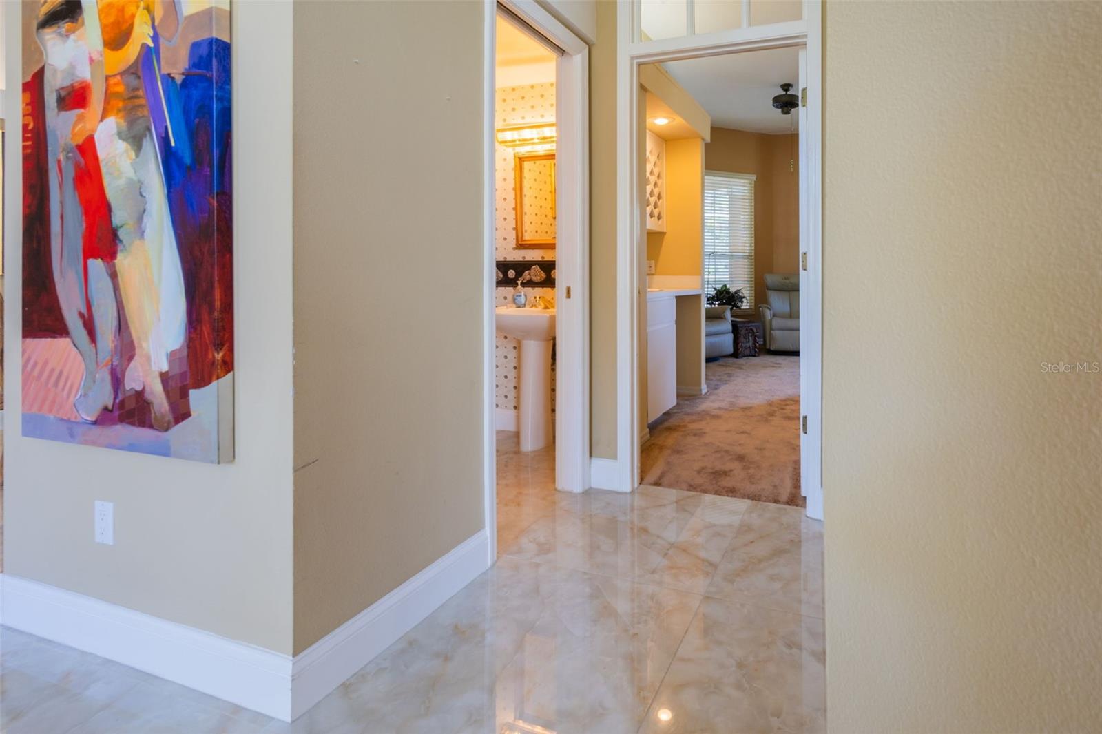 Door to the left is the 1/2 bath for company... and straight ahead is the Main Primary suite.