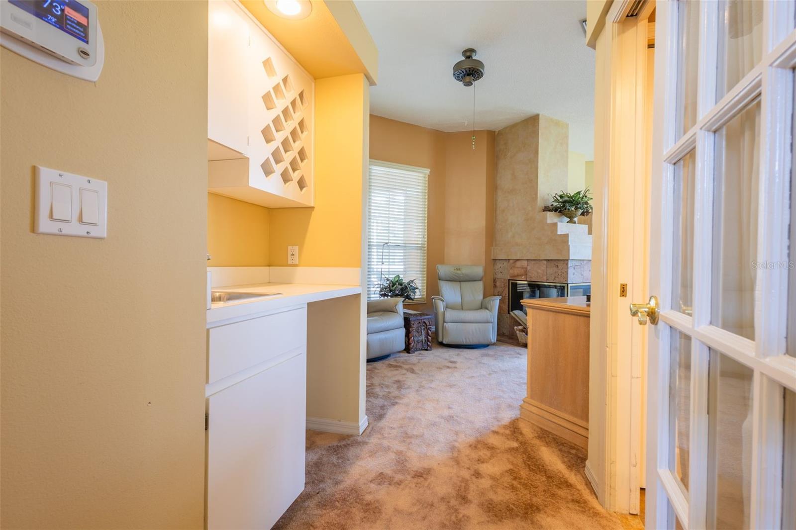Walking into the Main Primary suite, you have a wet bar to the left.