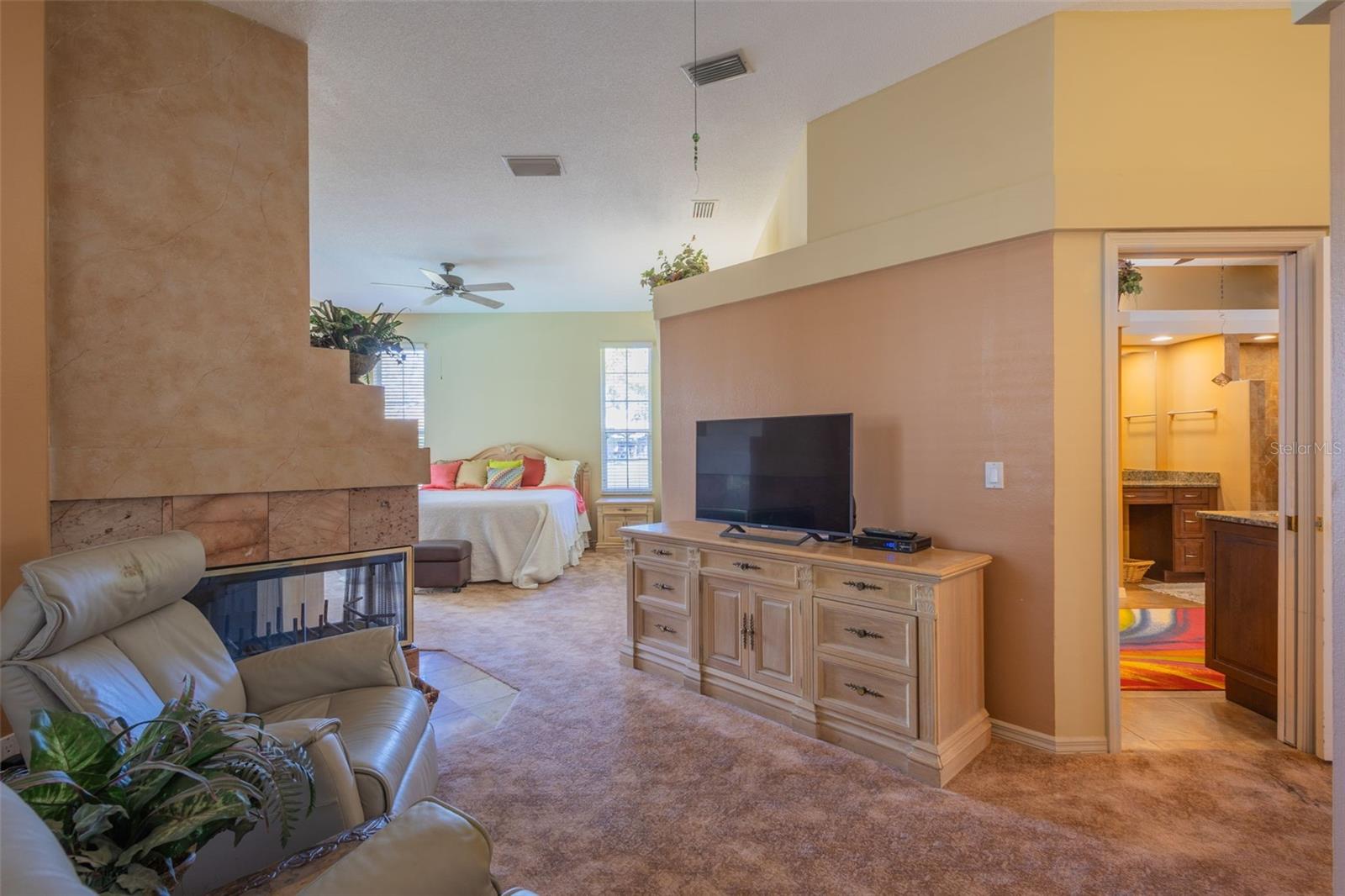 Primary sitting room, door on right is the on-suite bath. This room has it's own Fireplace (shown on the left)