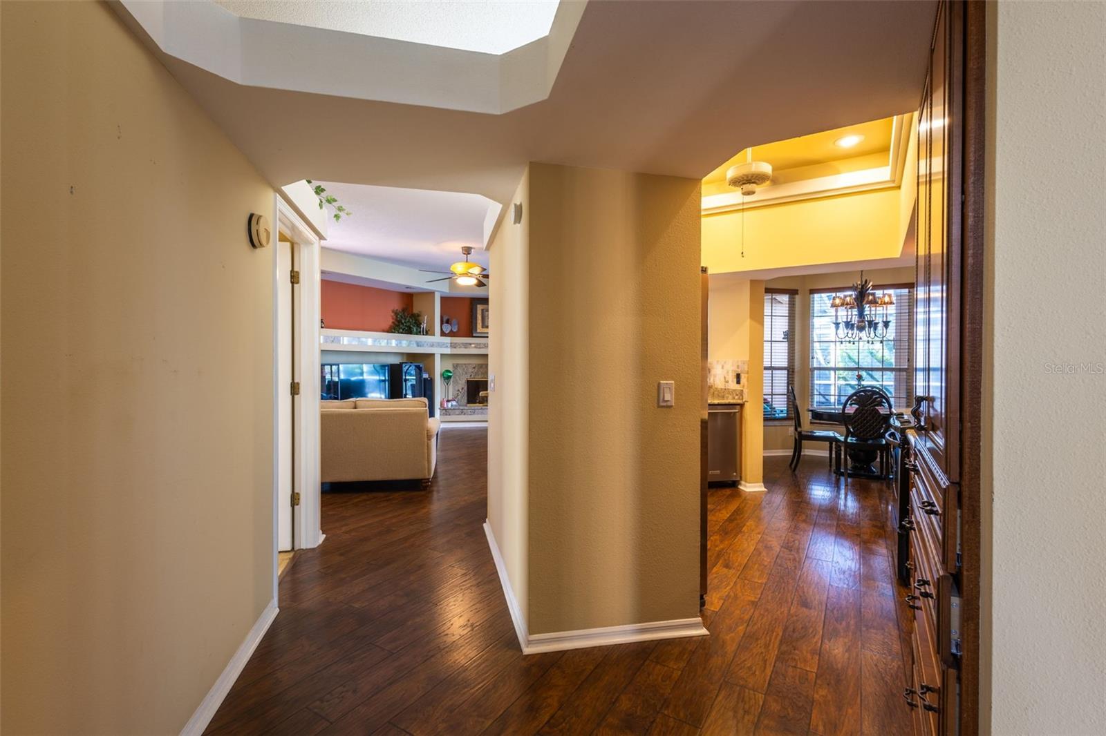 Leaving the Formal living area, you will find the kitchen to the right, and the Family room straight ahead. Notice the custom features around the top of the wall through out the home and some of the ceilings.