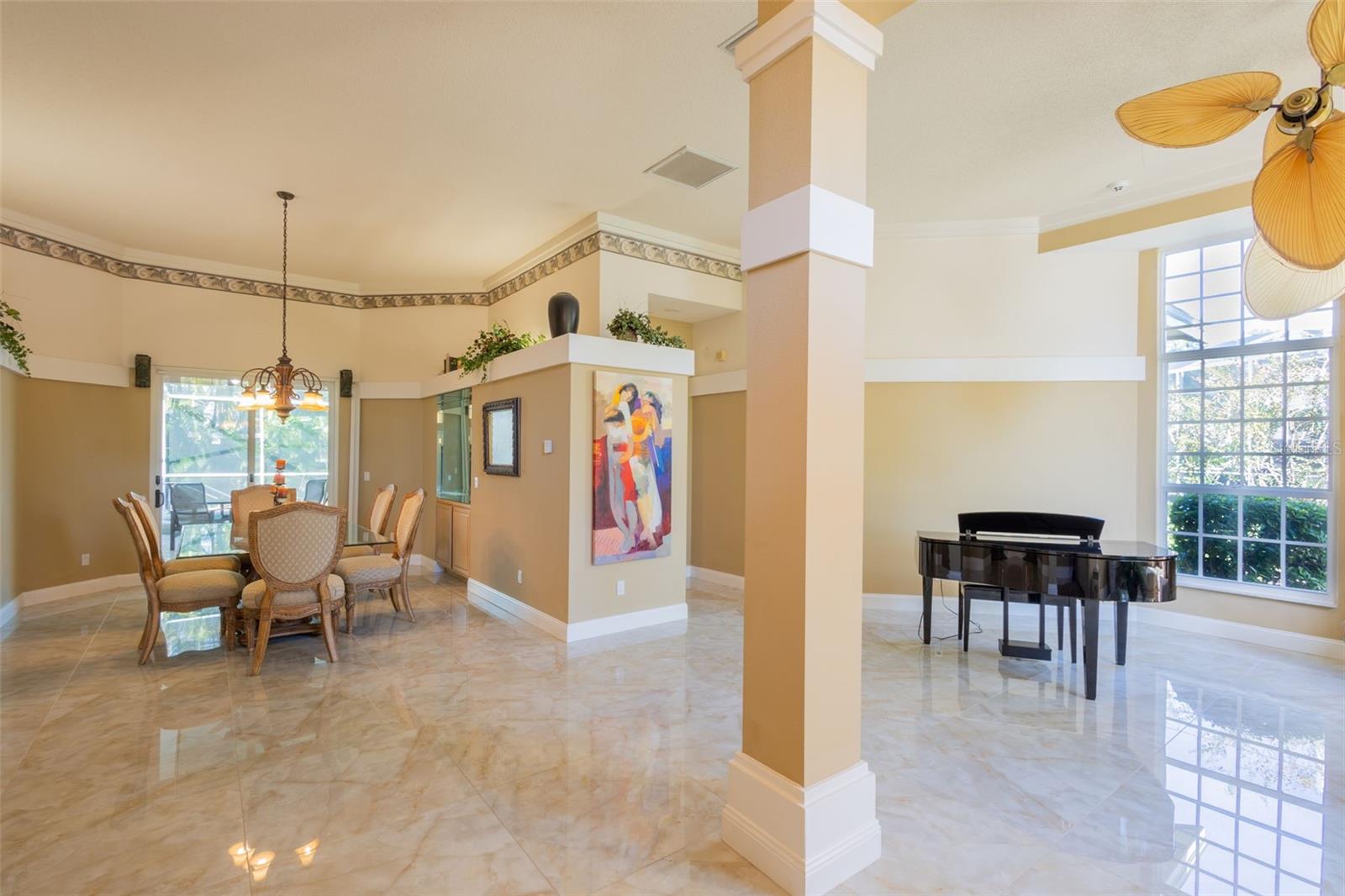 Entering the formal living and dining area. A beautiful glass tile, with sliding doors to the Lanai and pool.