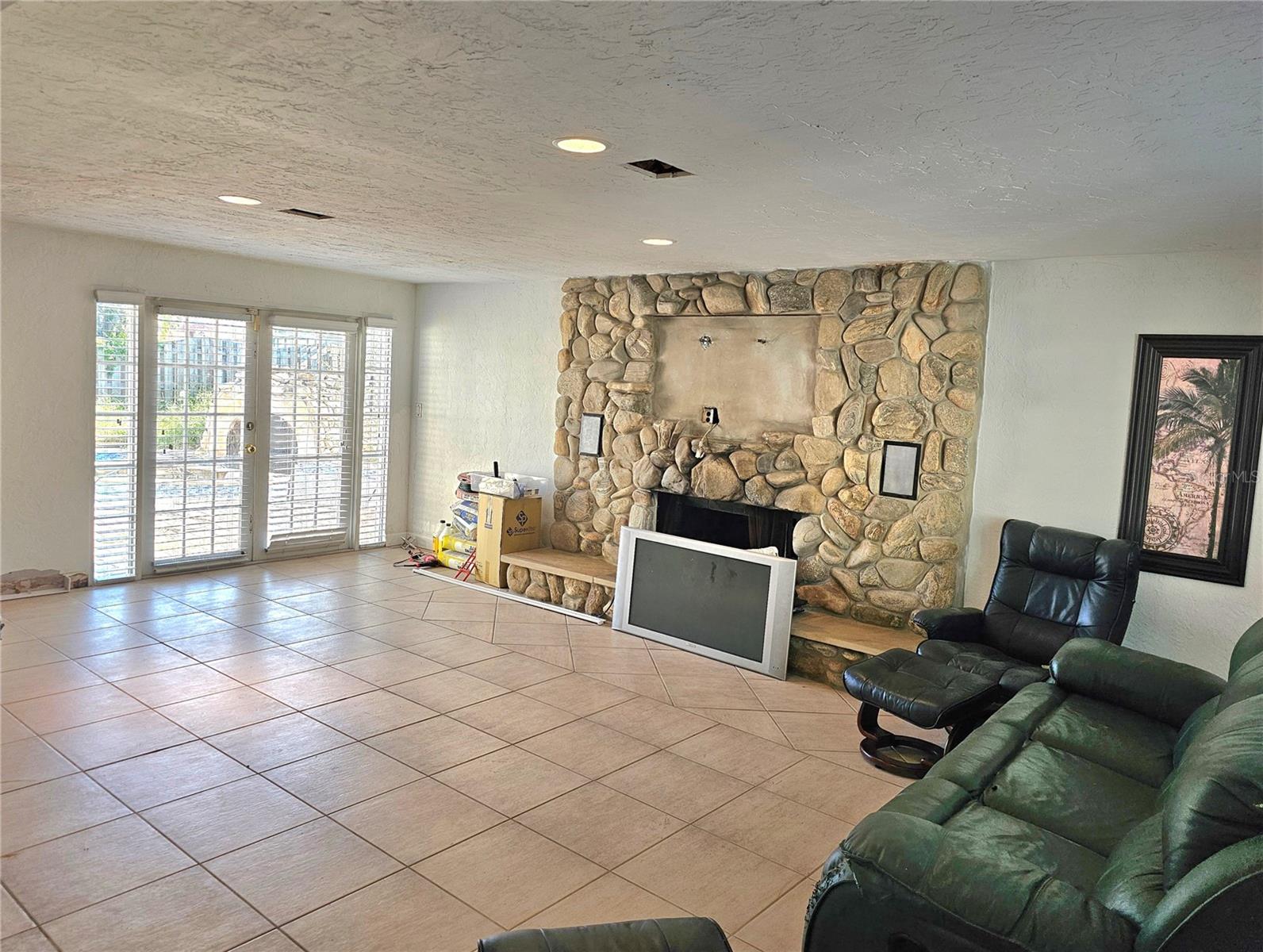 Family room leading to rear yard and pool area.