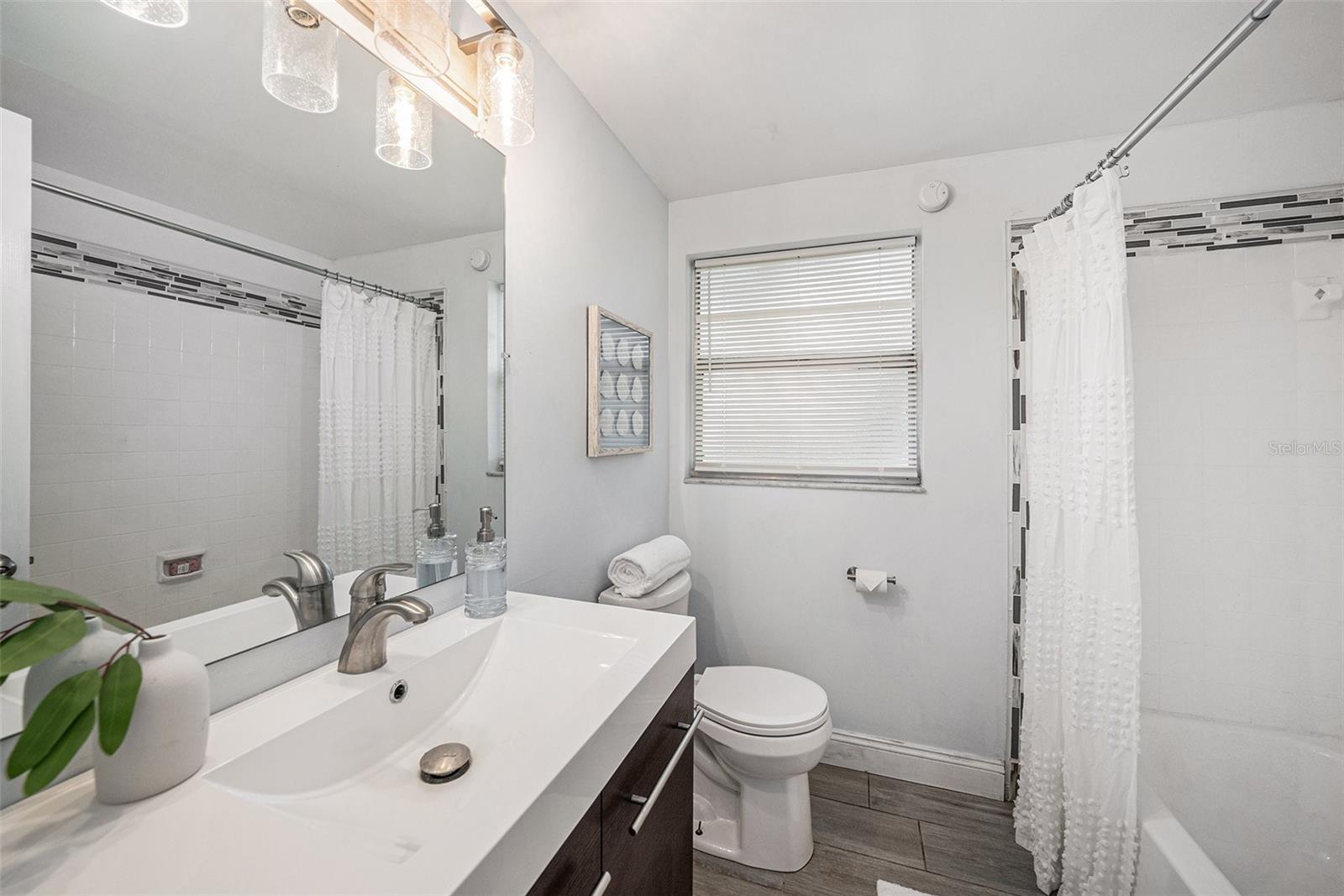 Bathroom #2 with contemporary vanity and shower/tub combination