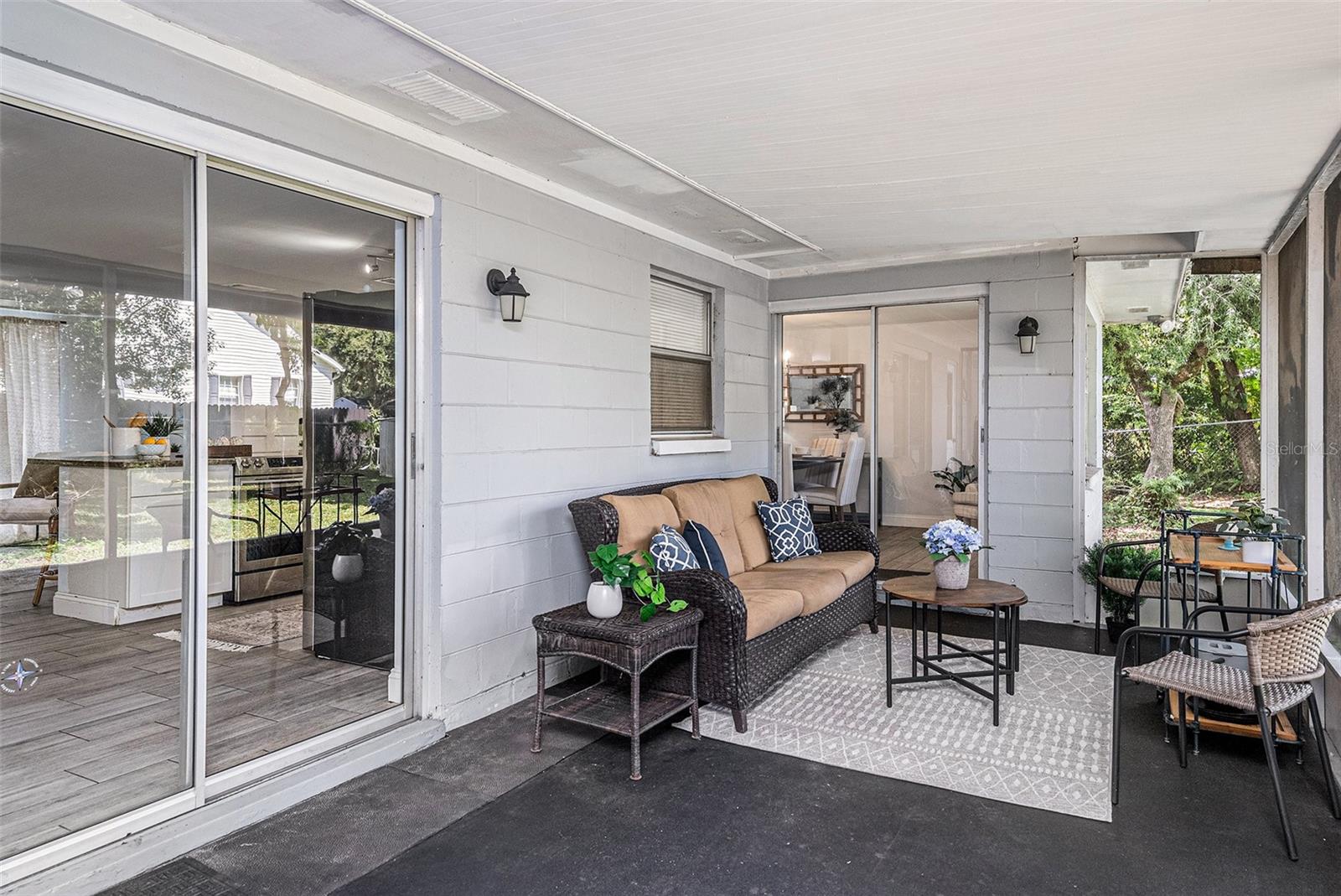 Two sets of double sliding doors are great for opening the home to feel Florida breezes on screened lanai
