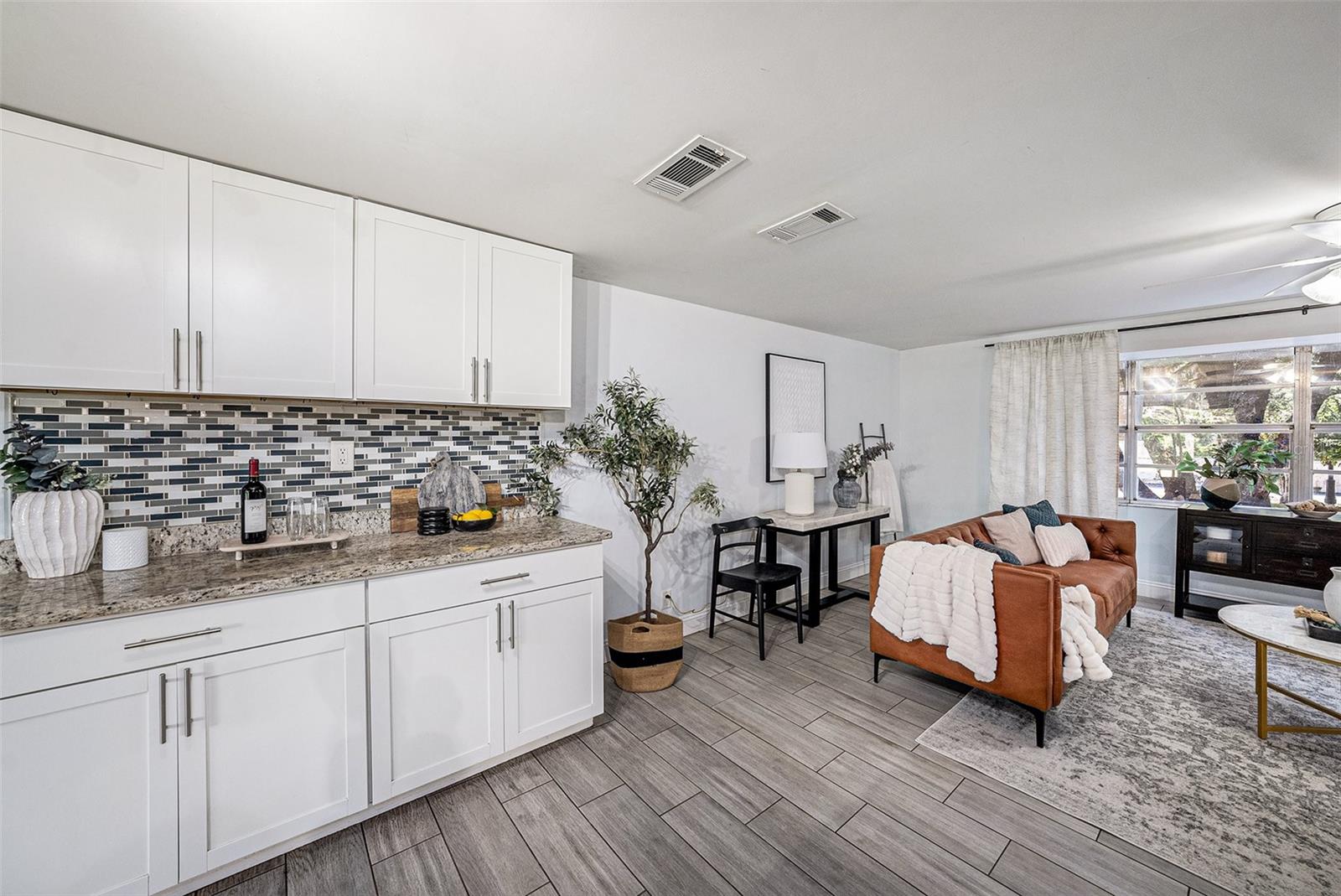 Entertainment dry bar with plenty of cabinets for storage
