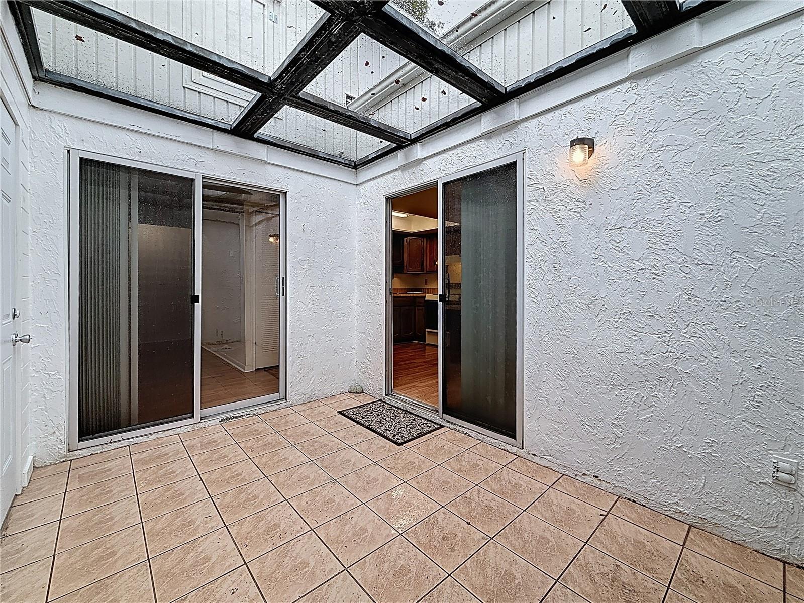 Atrium with access from Kitchen, Living Room, Garage
