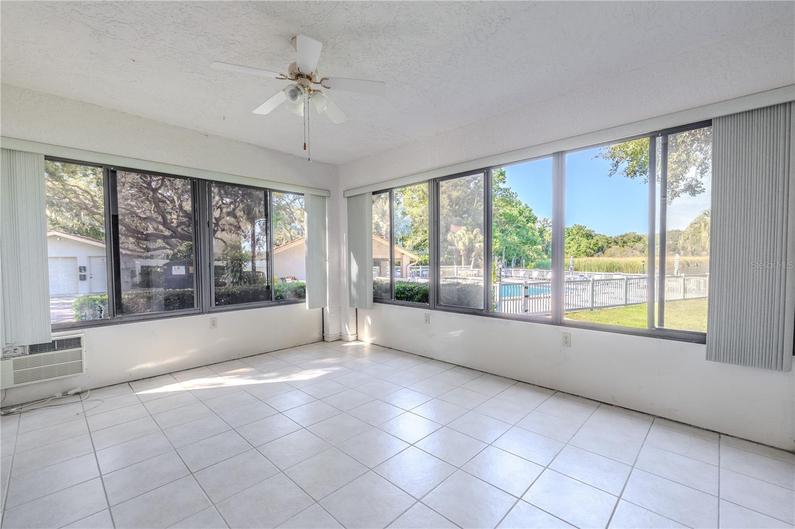 Enclosed lanai with wraparound windows, the perfect spot to enjoy Florida living year-round.