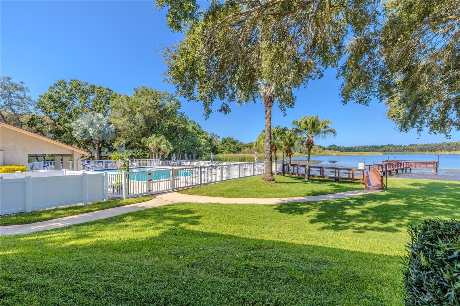 Beautifully maintained grounds with open green space, walking paths, and lake access nearby.