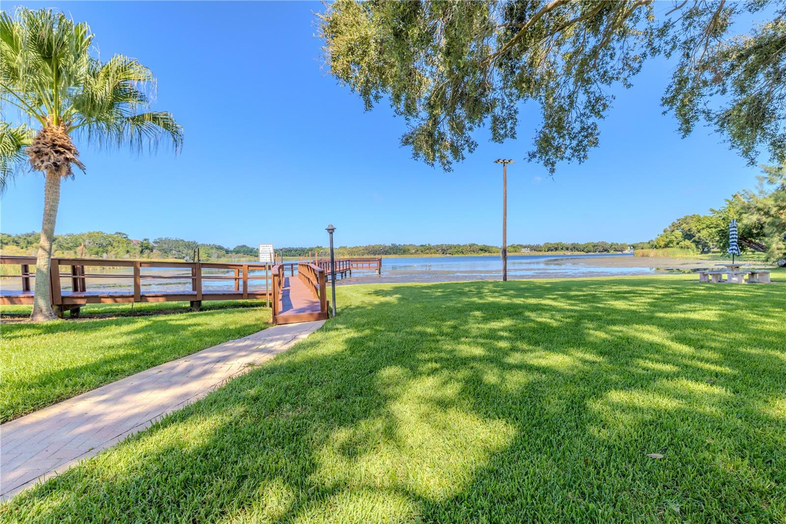 Manicured grounds frame the way to the community’s fishing pier.