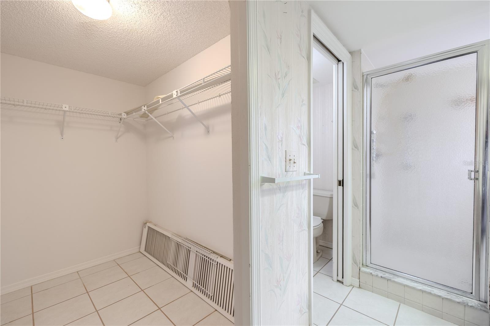 Primary bathroom includes a spacious walk-in closet perfect for staying organized.