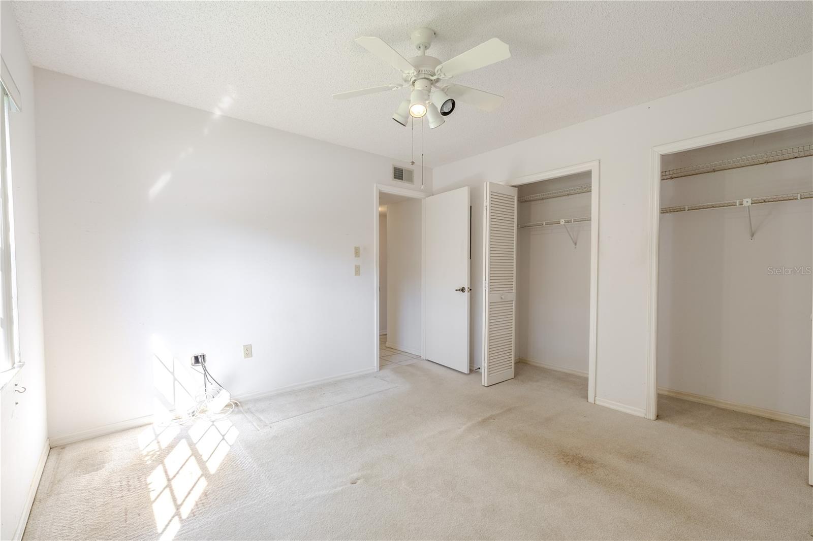 With dual closets and plenty of space, this bedroom adapts easily as a guest suite, office, or hobby room.