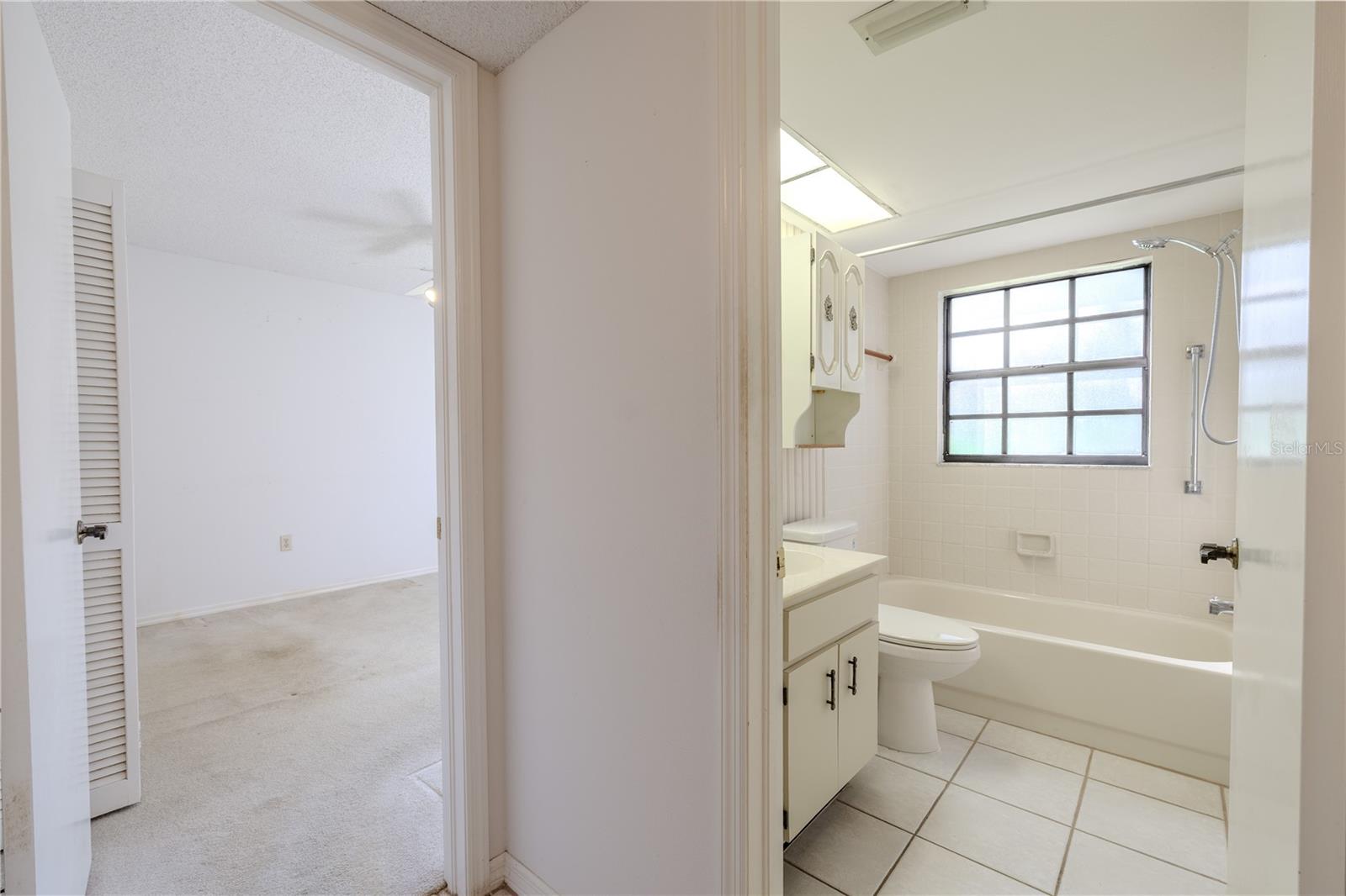 The guest bath offers a practical single vanity with storage below, ready to serve visitors or daily use with ease.