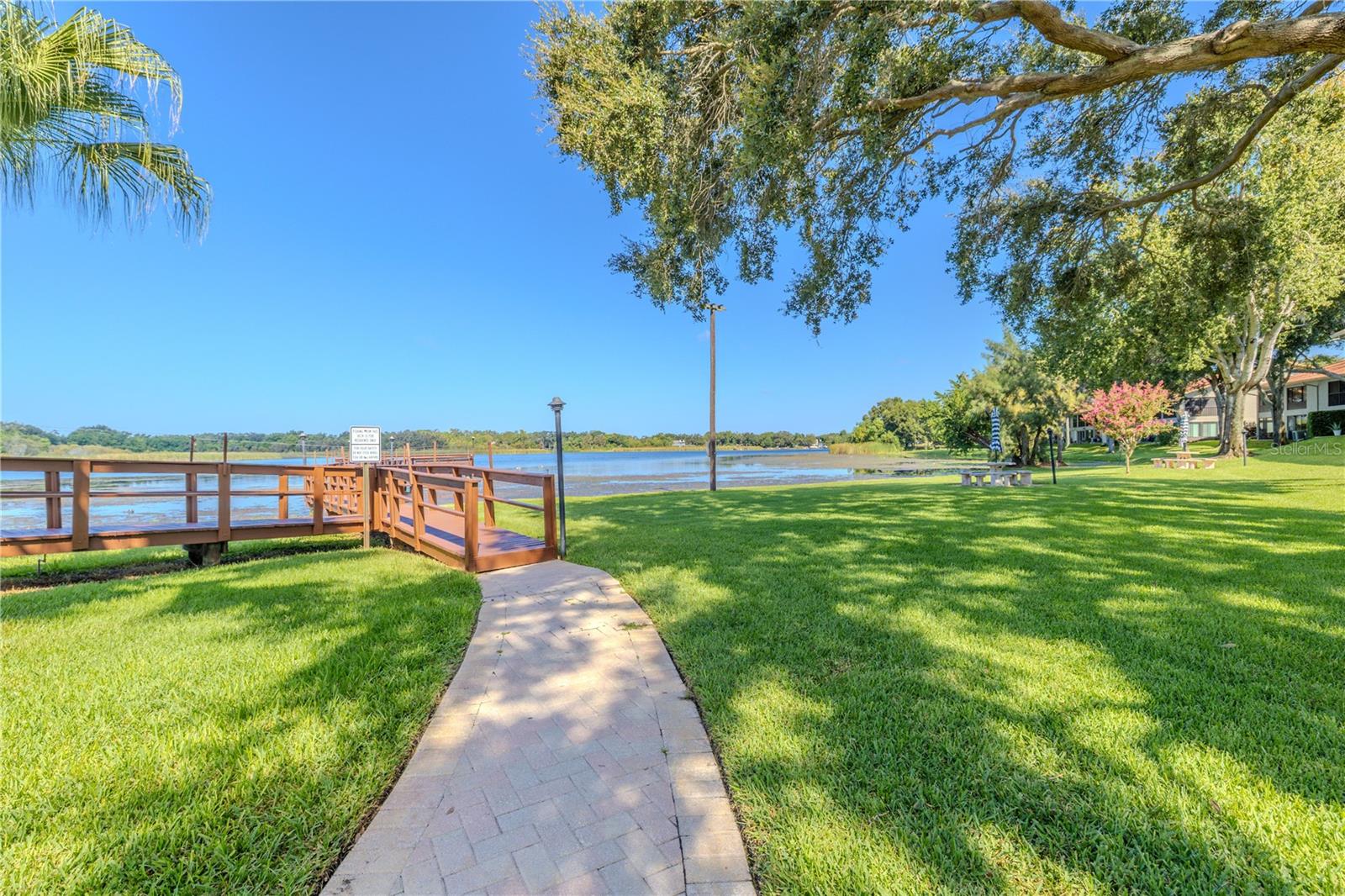Peaceful walkway leading to the lakefront pier and beautiful water views.