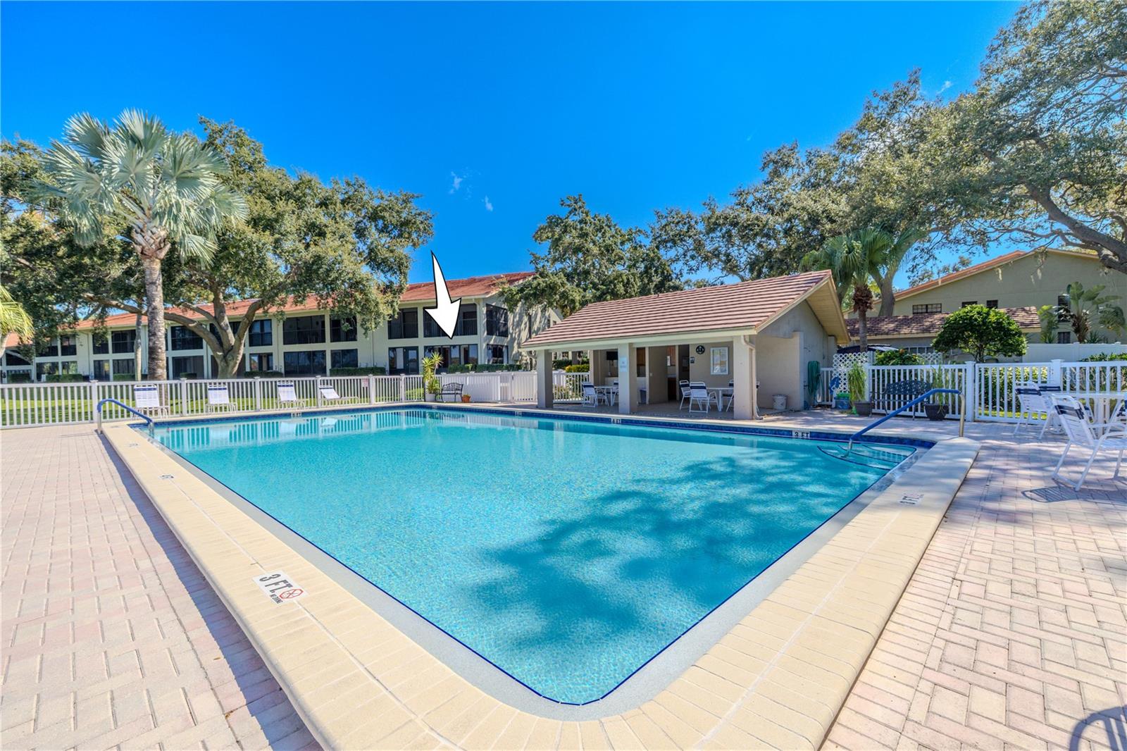 Sparkling heated pool with lake views, which is the centerpiece of Villas of Lake Arbor.