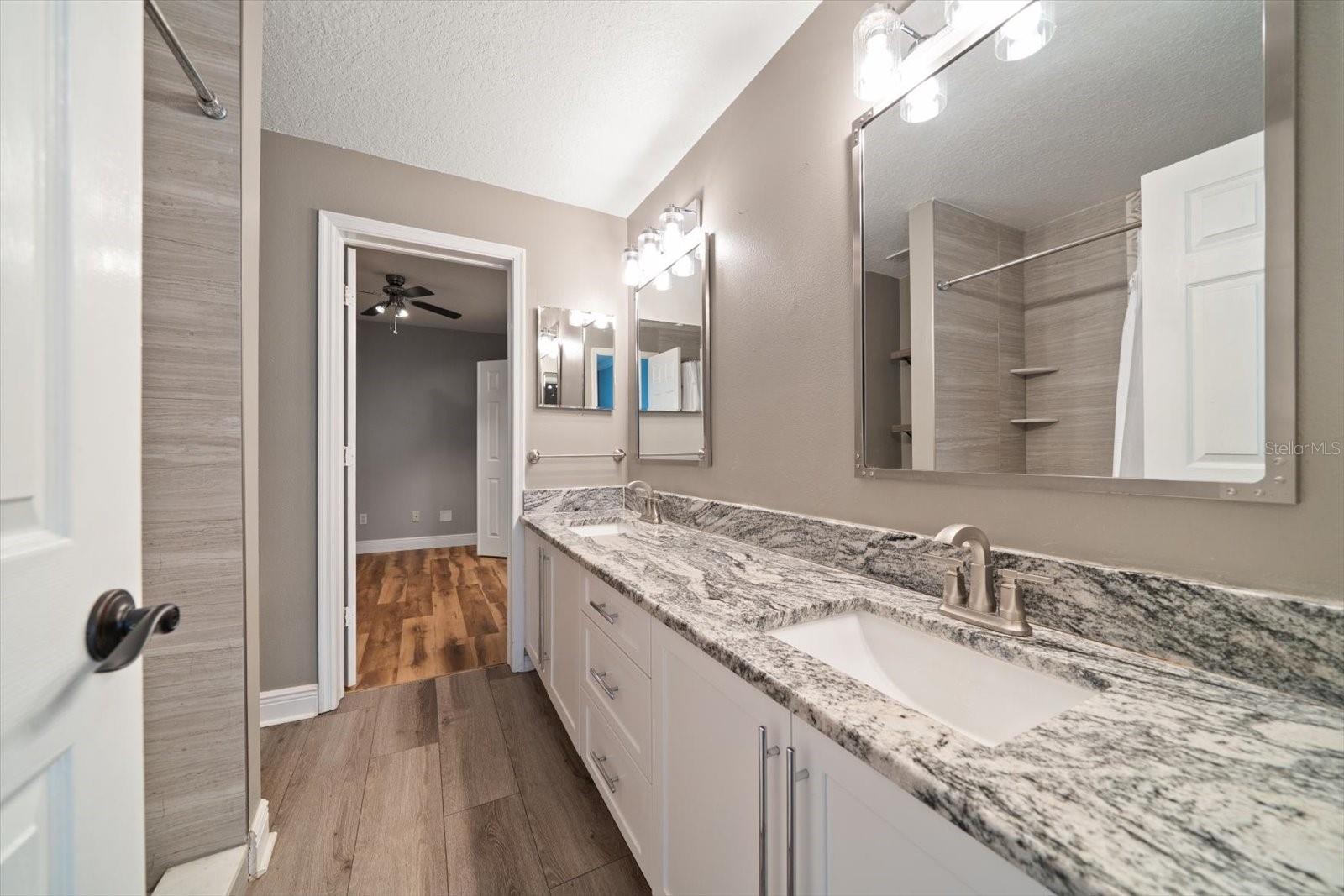 Primary en suite full bath with dual vanities