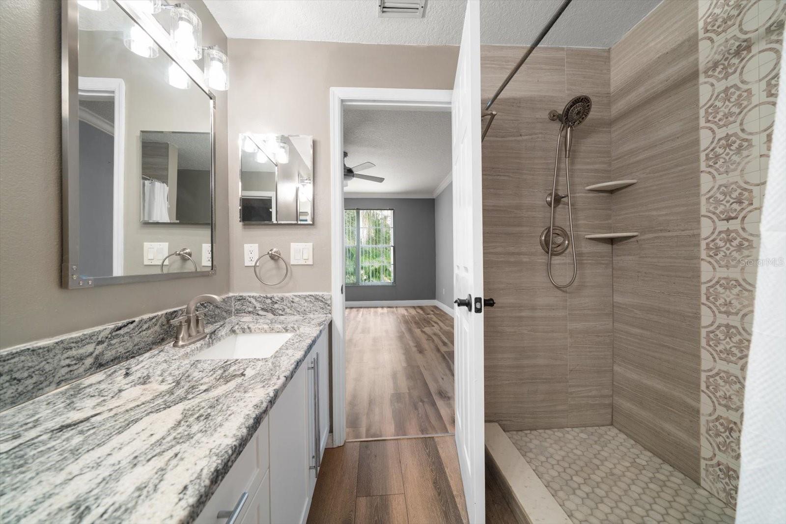 Primary en suite full bath with dual vanities & beautiful step in shower