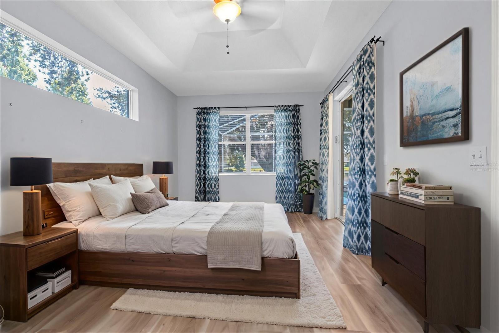 Primary bedroom - door to the pool - Virtually staged